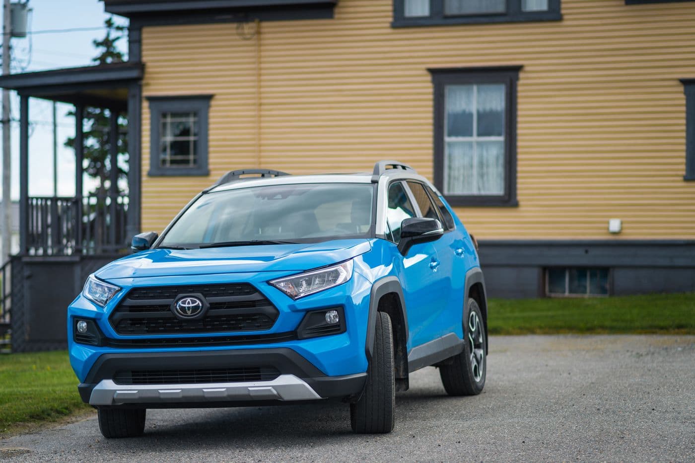 Blue compact SUV parked on a gravel road, similar to a Chevrolet Equinox